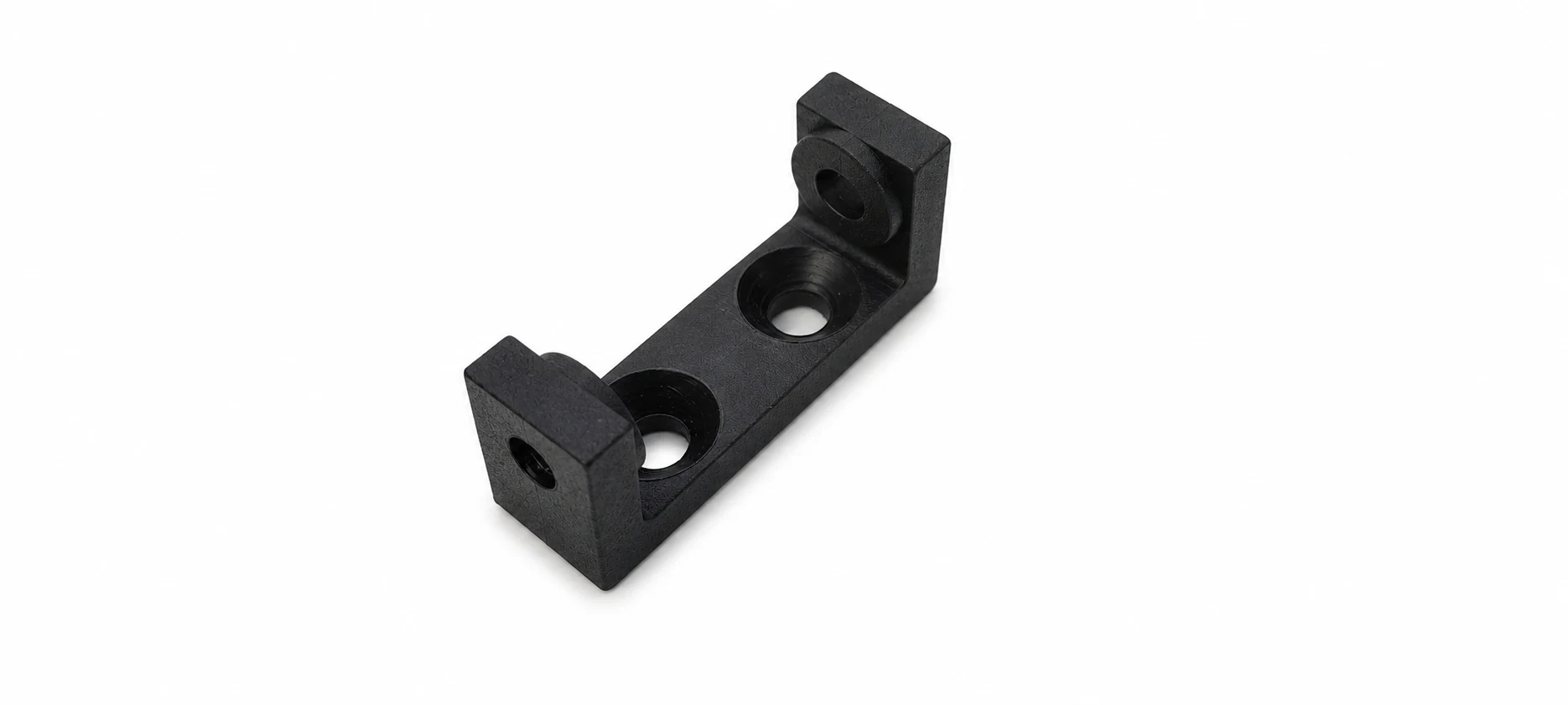Black moulded mounting bracket with countersunk holes